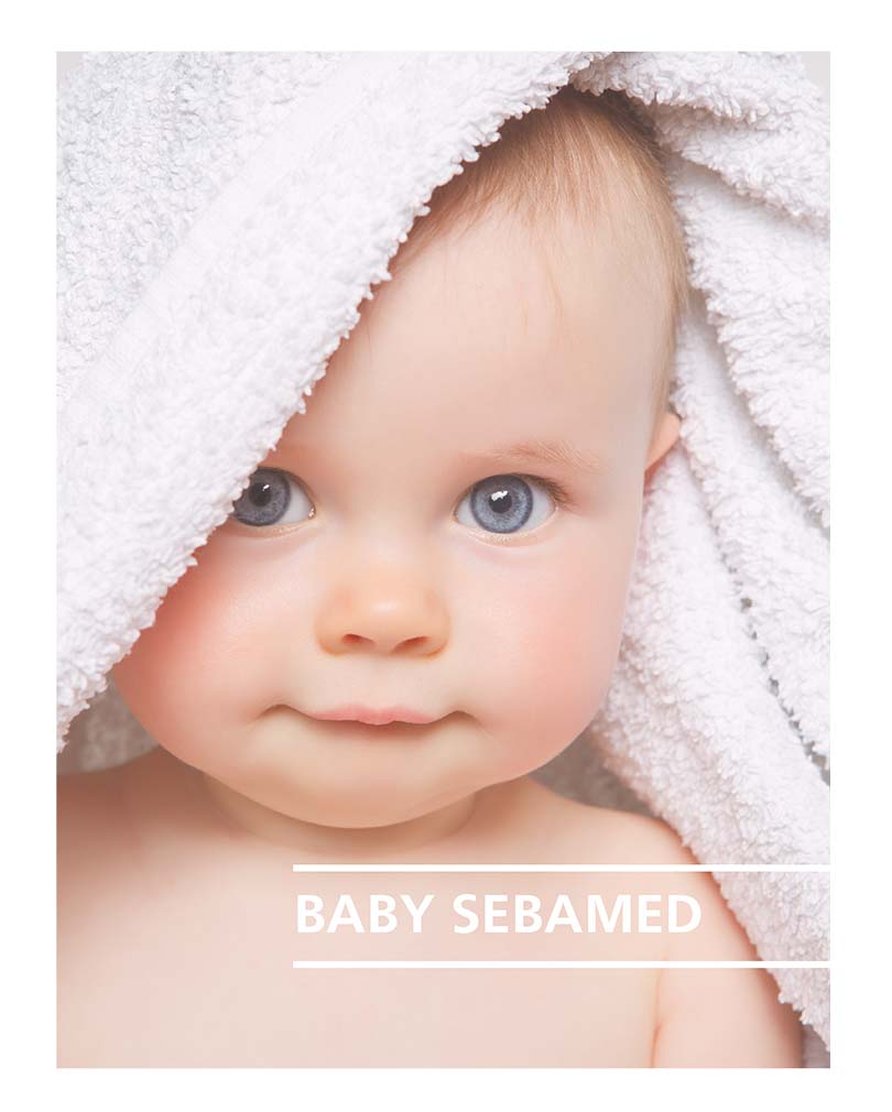 Baby with blue eyes and white towel over head